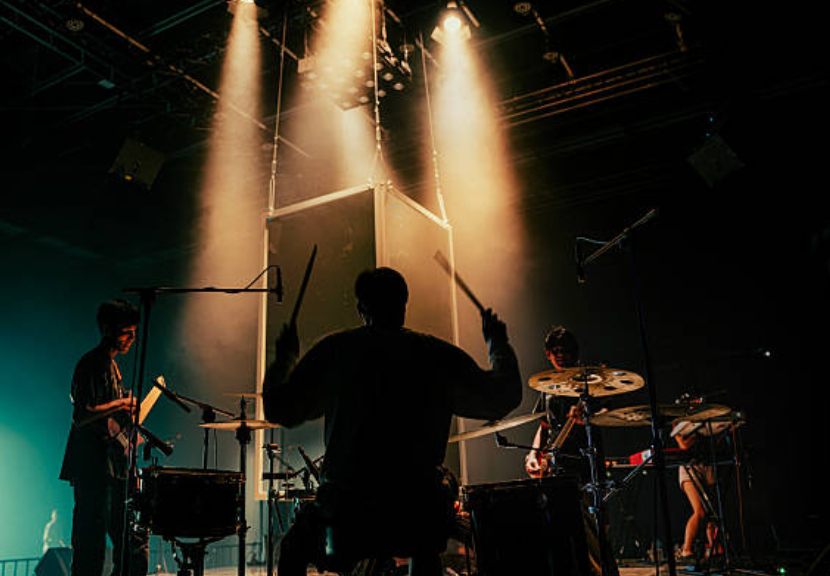Band members recording in a studio